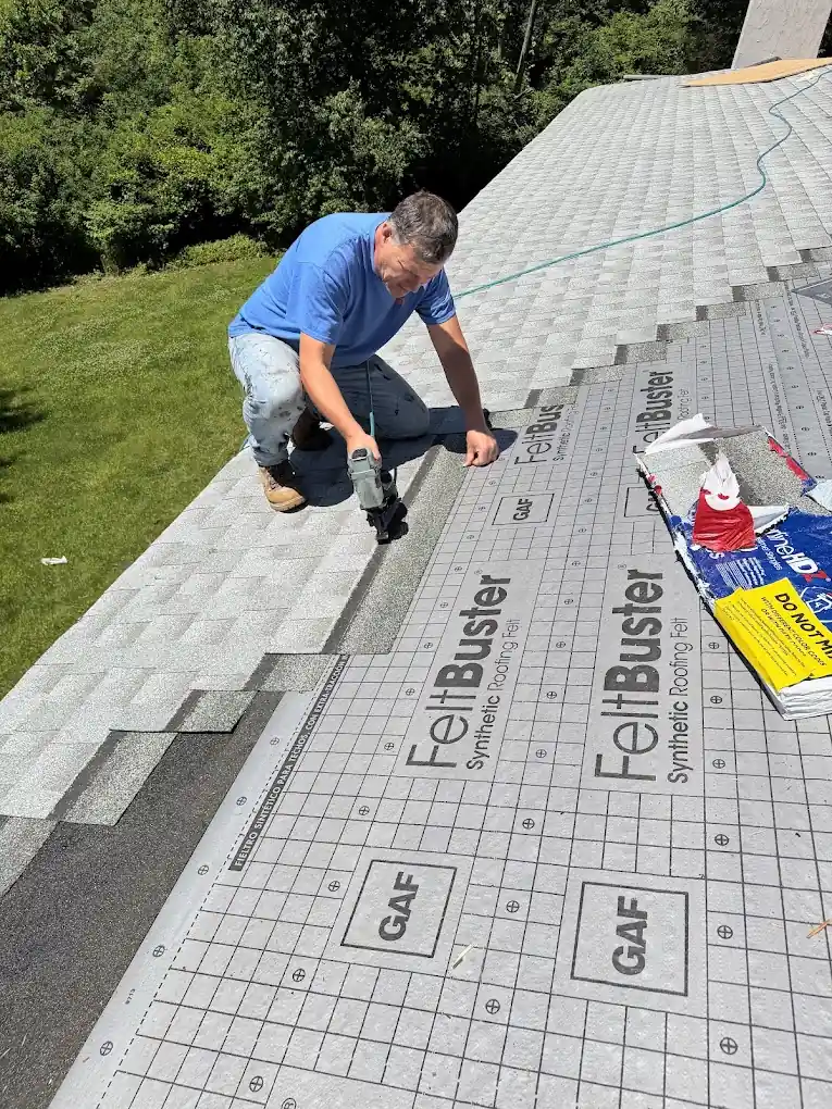 American Sons Roofing crew installing shingles