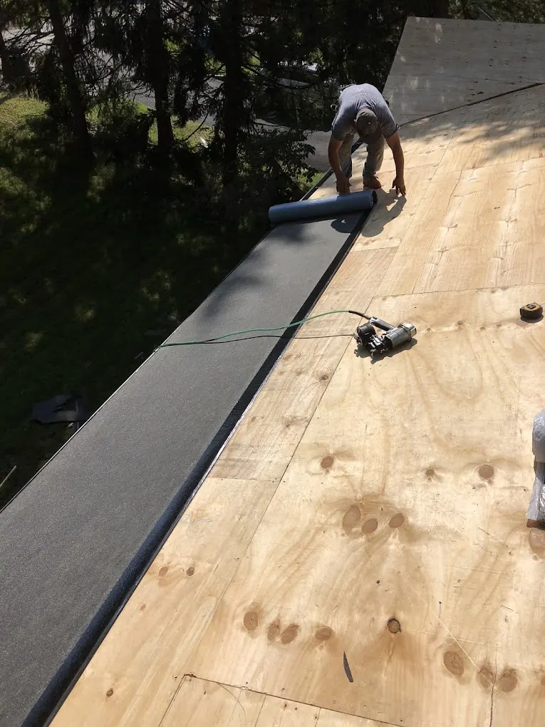 American Sons Roofing crew preparing roof underlayment