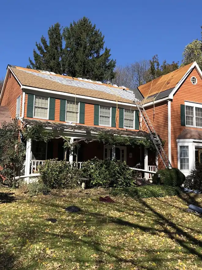 American Sons Roofing roof replacement project on an orange home